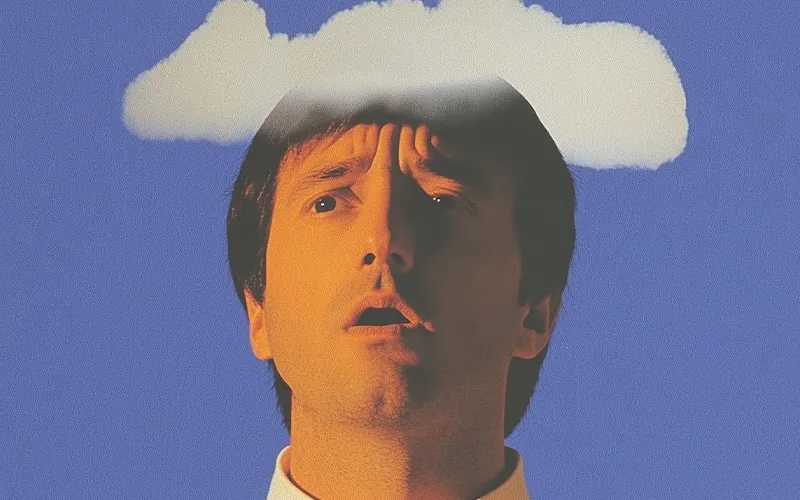 A man with a white cloud over his head against a blue background