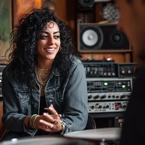 Laughing in a denim jacket in the studio