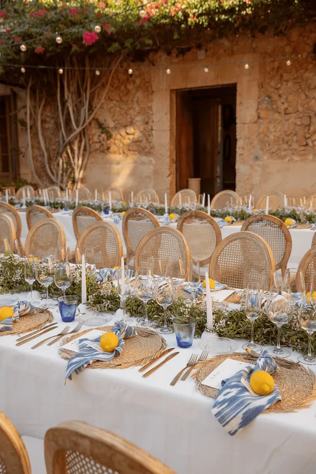 A candle-lit courtyard table set for a celebration