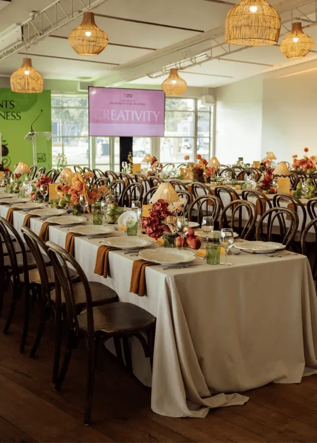 A banquet hall with long tables and floral centrepieces