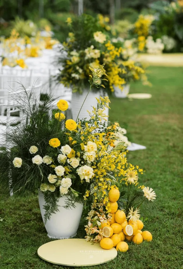 Yellow flower arrangements with lemons on a garden lawn