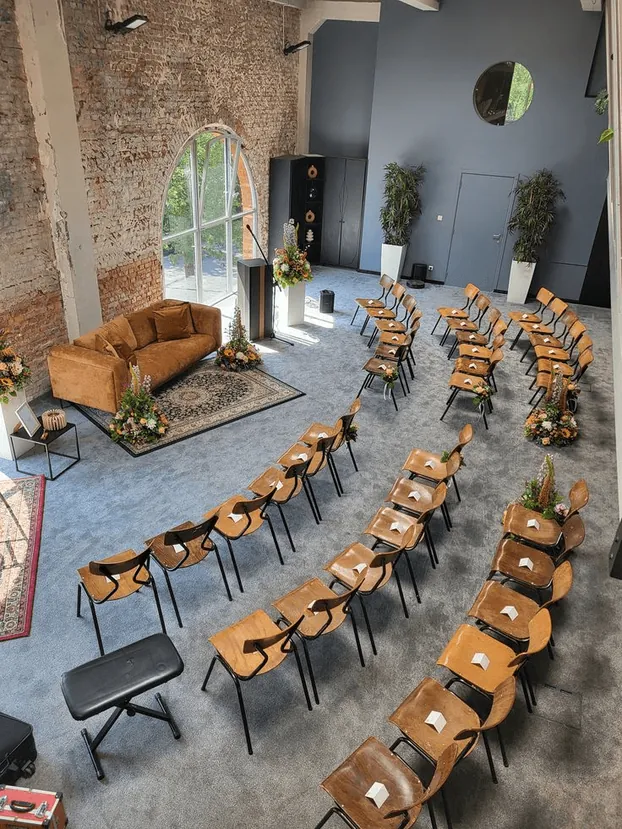 A circle of chairs set for a workshop in a bright loft