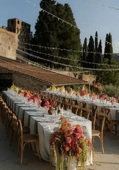 Long reception tables on a terrace under string lights