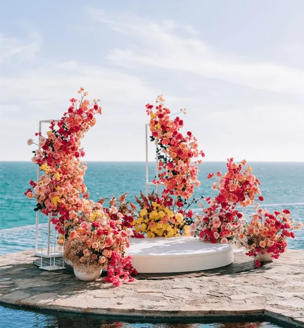 A crescent of pink flowers on a seaside terrace