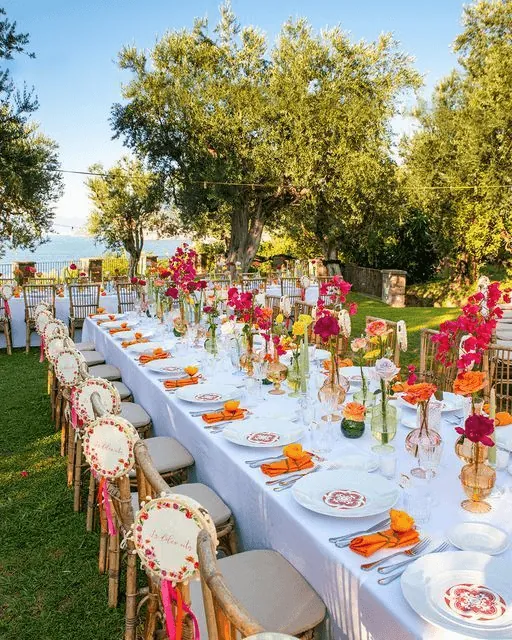 A long garden table with bright summer flowers