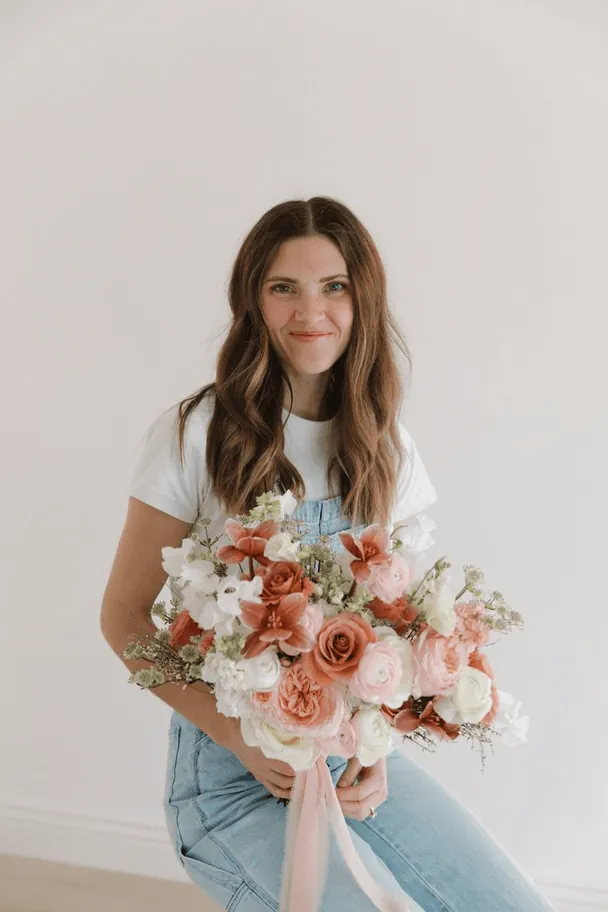 Sophie Bennett holding a bouquet of peach roses