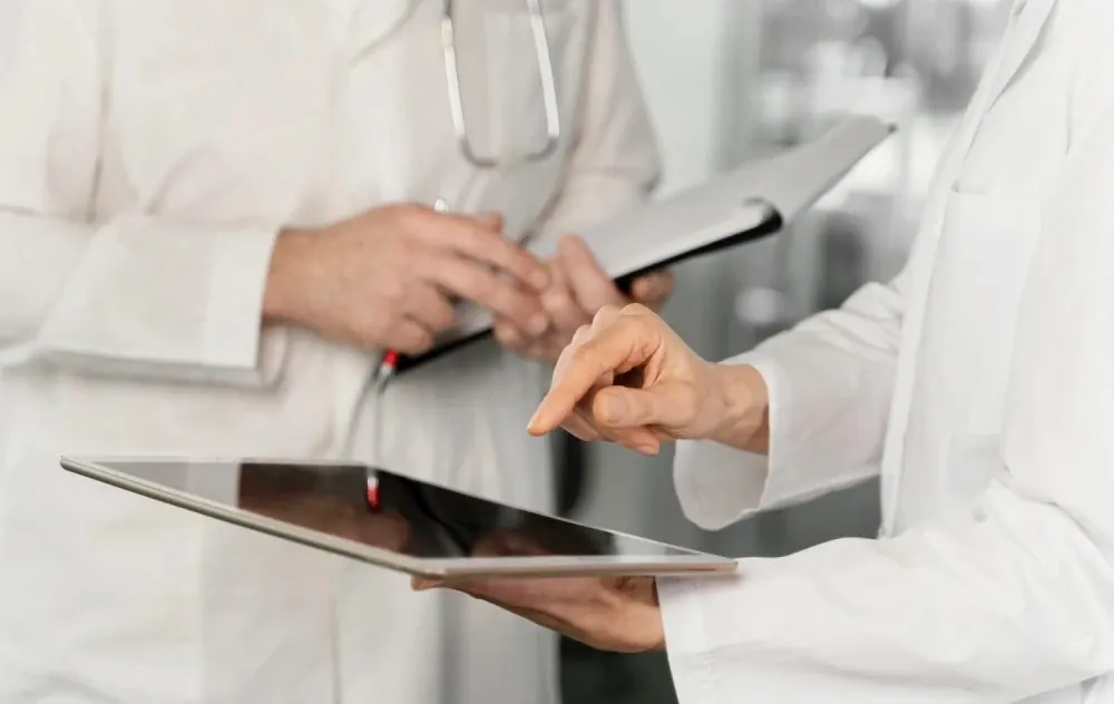 Doctors going over notes on a tablet