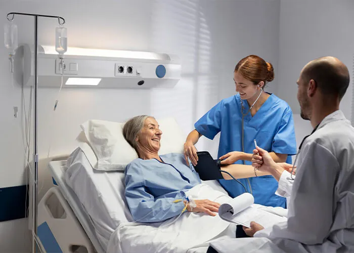 A nurse checking an older patient’s blood pressure in bed