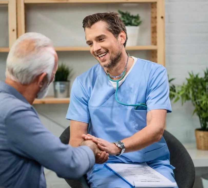 A smiling doctor with an older patient