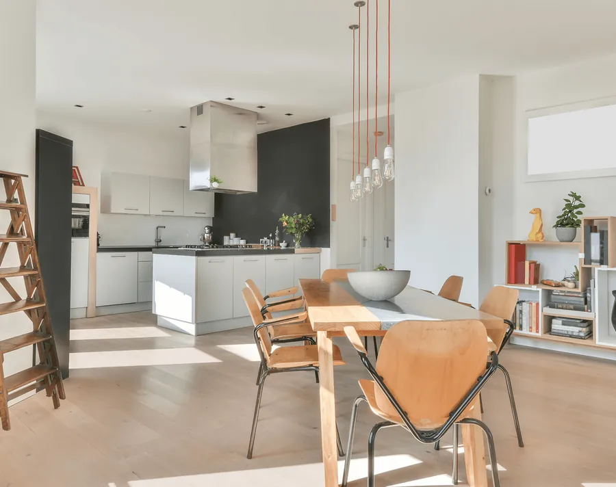 An open kitchen and dining room with wooden chairs