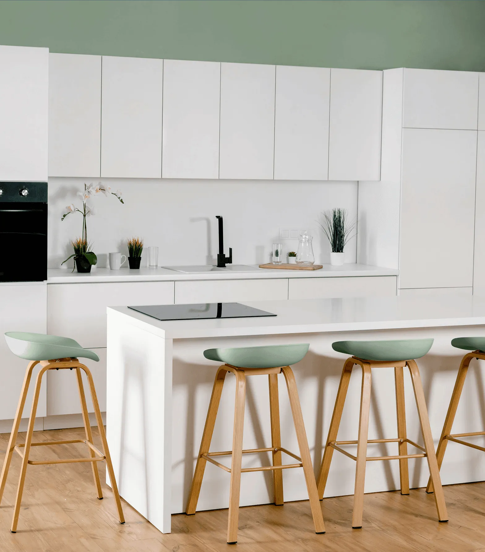 A white kitchen island with green bar stools