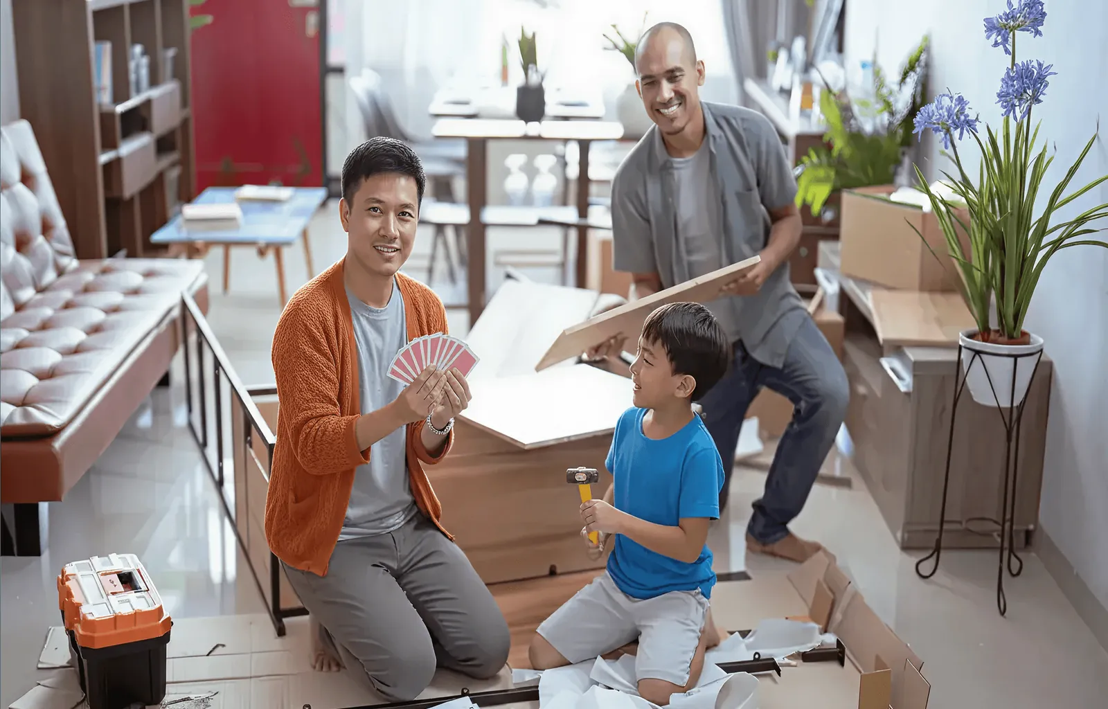 A family unpacking boxes in their new living room