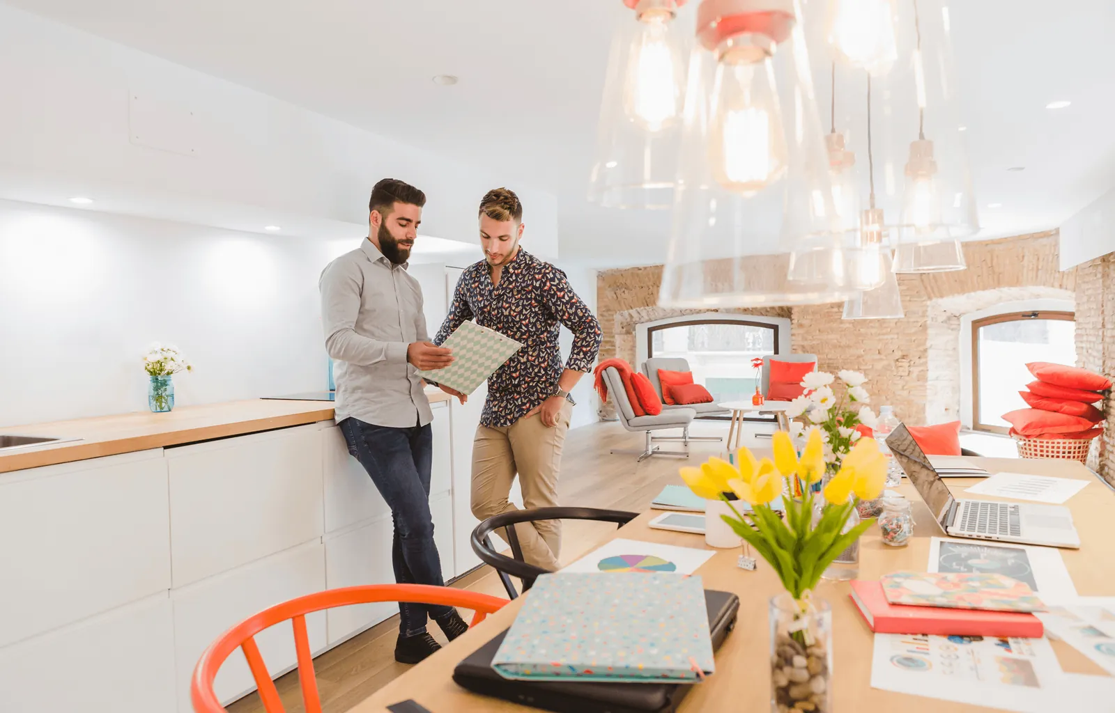 Two men looking at samples in a bright kitchen
