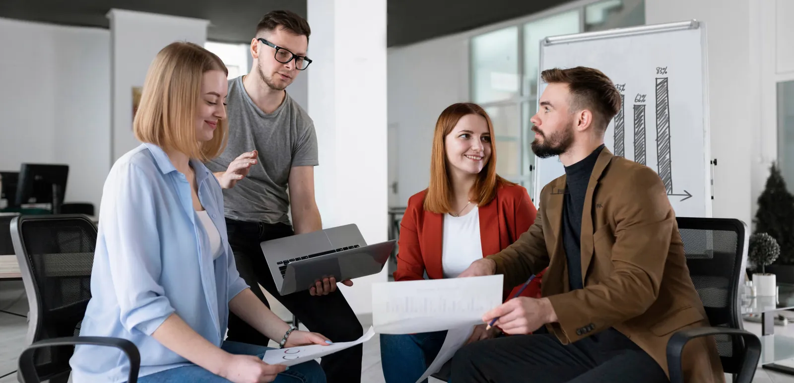 Colleagues reviewing papers together in an office