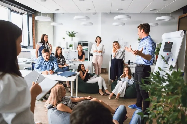 A team gathered around a presenter