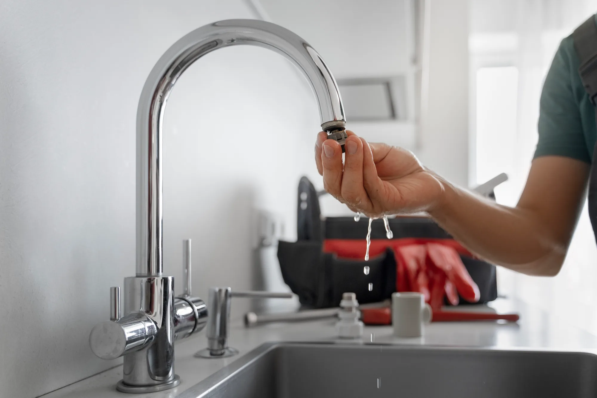 A glass of water under a chrome tap