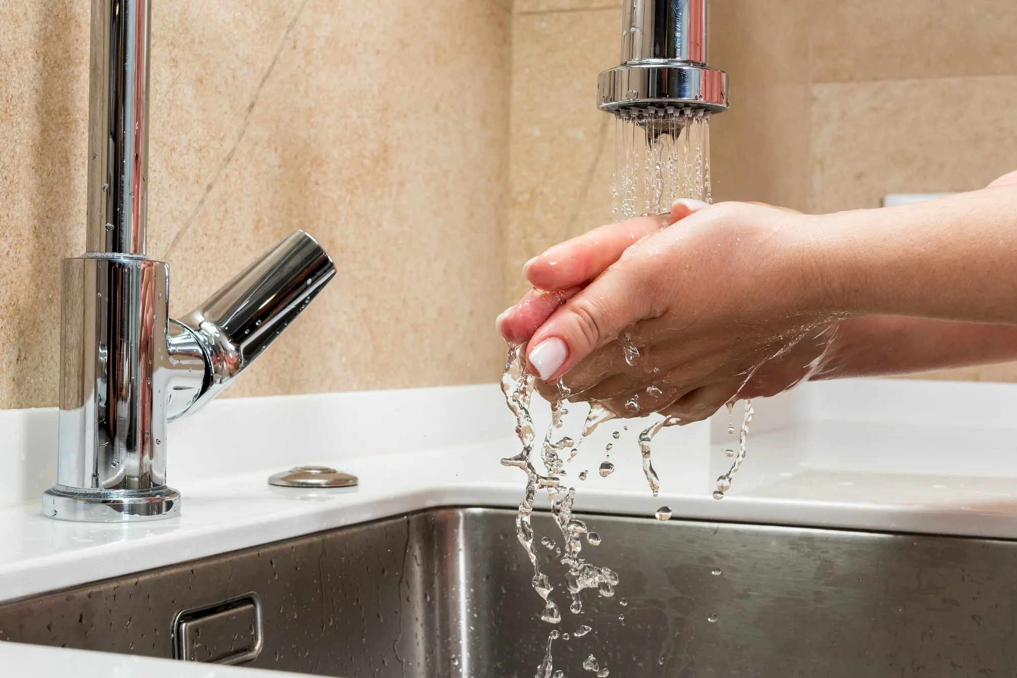 Hands washing under a running tap