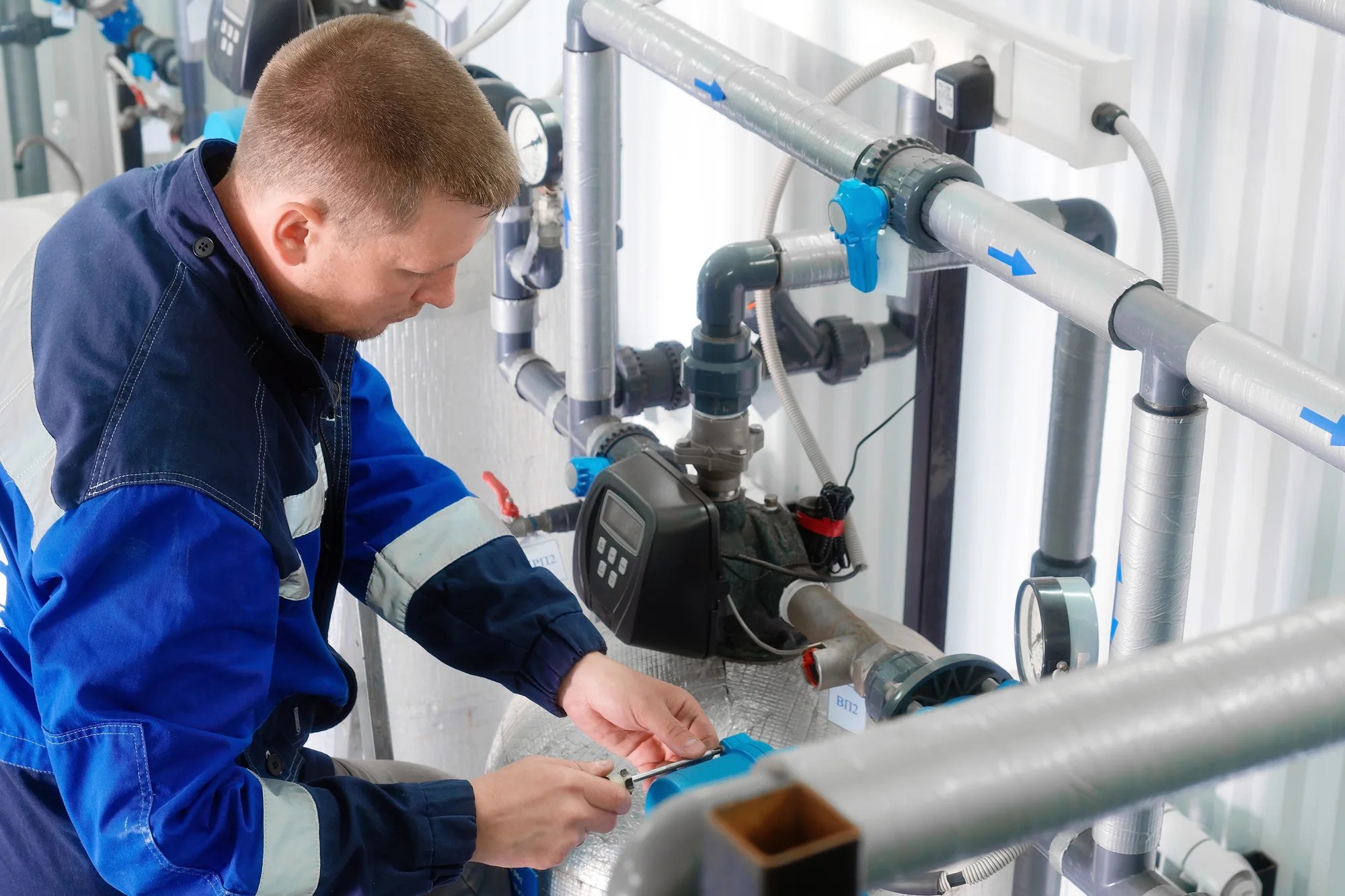 A plumber servicing a water heater