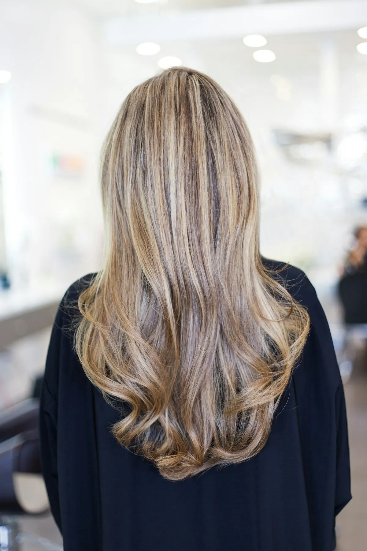 Long balayage hair from behind, blonde lengths over a darker root