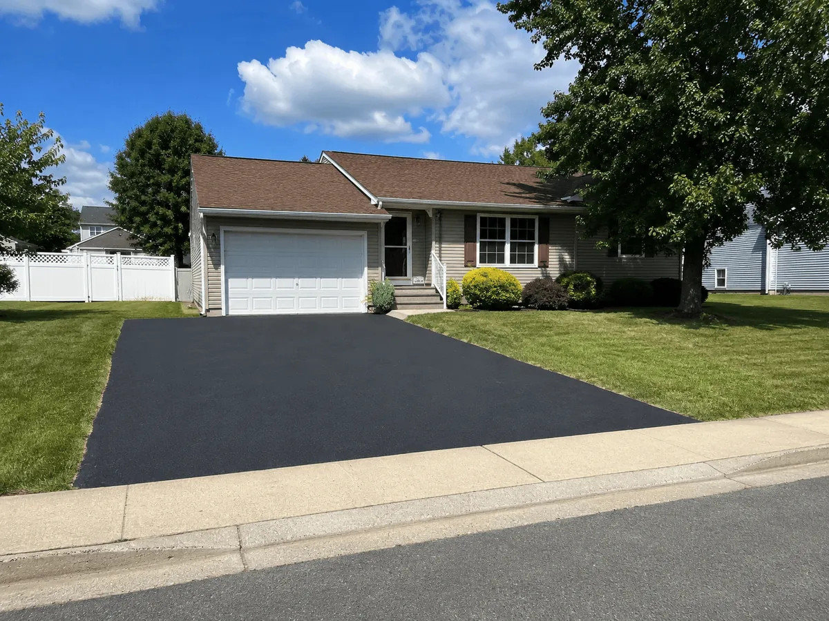 A resurfaced driveway in front of a ranch house in Sayville