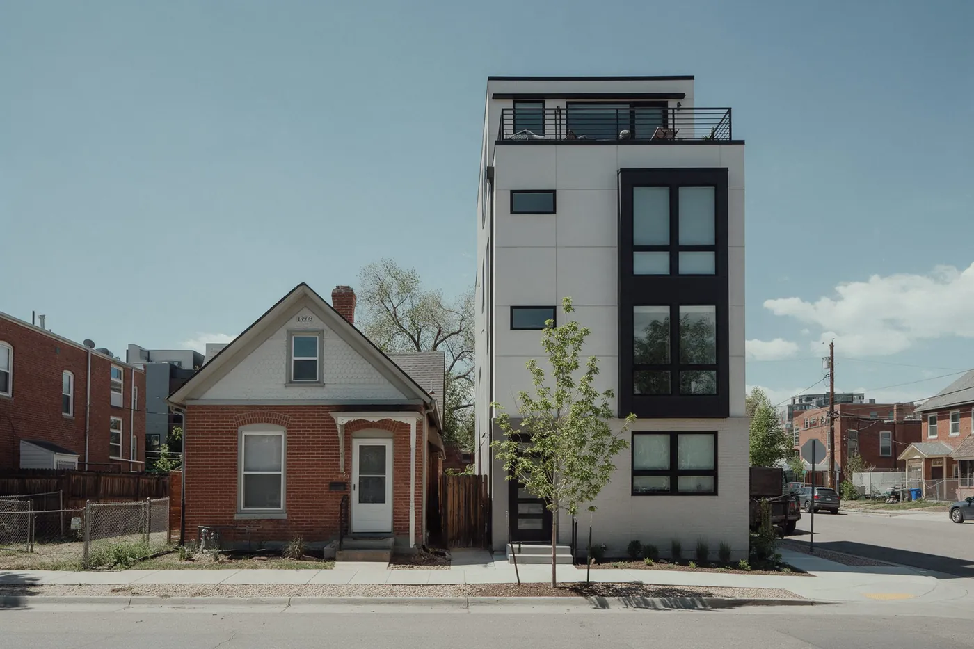 A Victorian brick cottage next to a new four-storey townhome in Highland