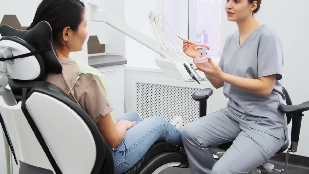 A dentist talking with a patient in the dental chair