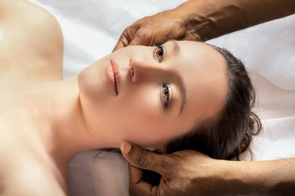 A woman resting her head in a therapist’s hands