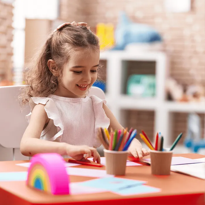 A girl drawing with coloured pencils