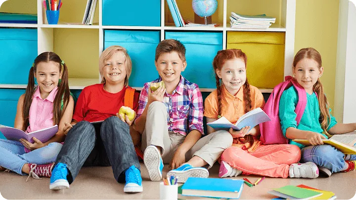 Nursery children smiling at their table