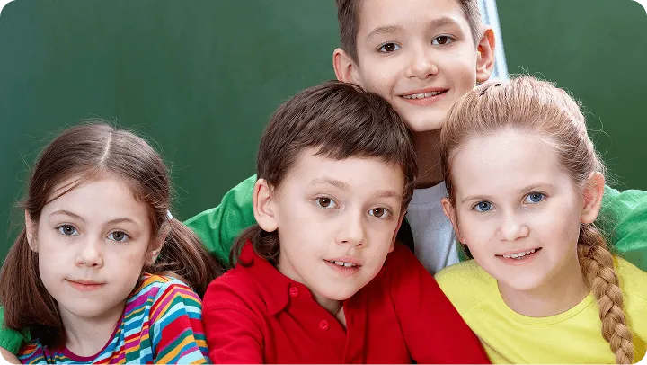 Three toddlers smiling together in class