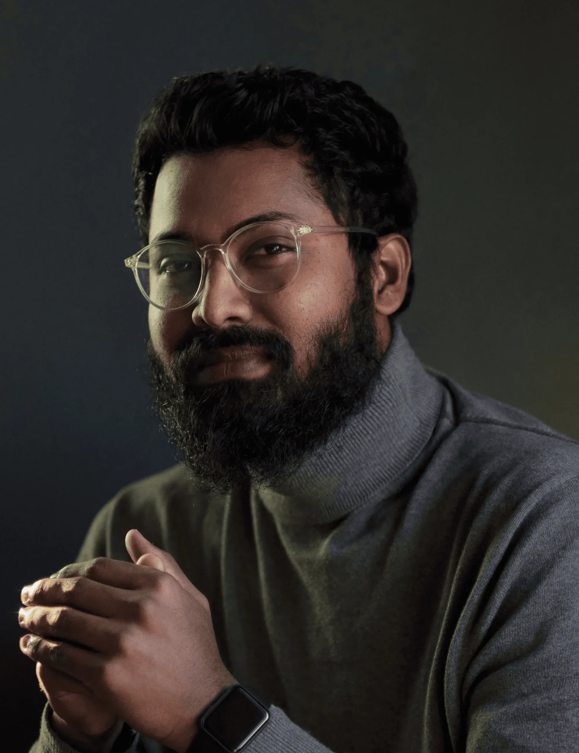 Alaric Thorne, chief pest officer, in glasses and a gray turtleneck