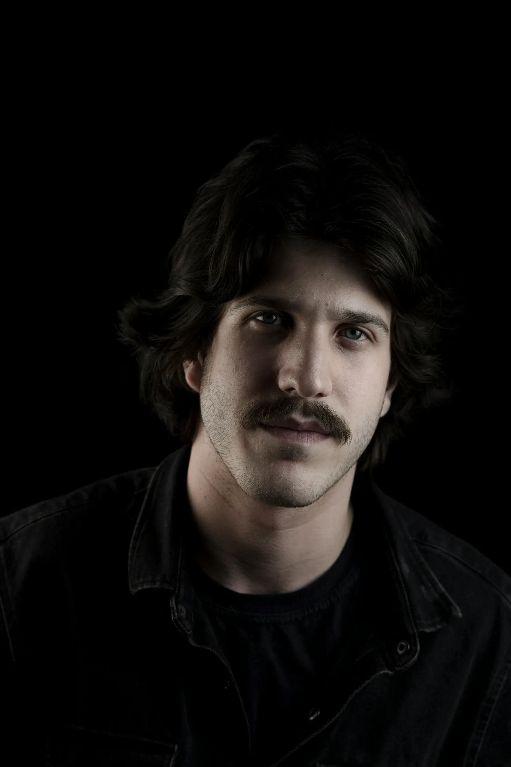 Osric Hale, field service technician, with wavy dark hair and a mustache