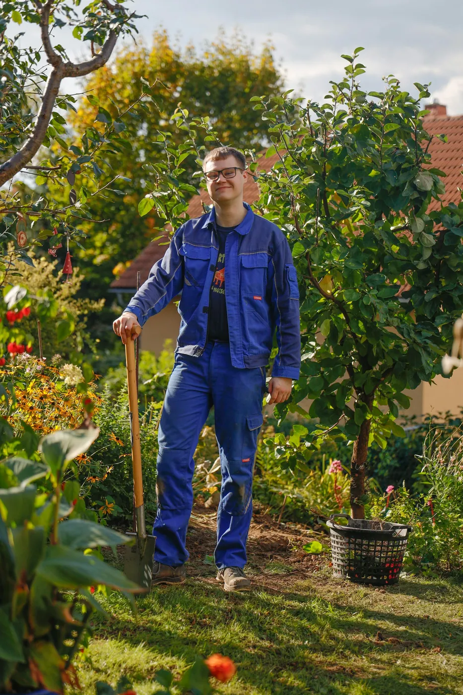 A gardener with a spade in an orchard