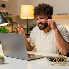 A freelancer on a call at his laptop