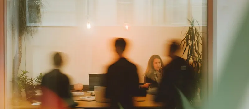 The team around a table in a warm-lit office