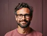 A bearded team member with glasses