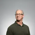 A client in glasses and a green polo shirt