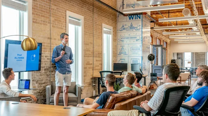 A consultant presenting to a team in a loft office