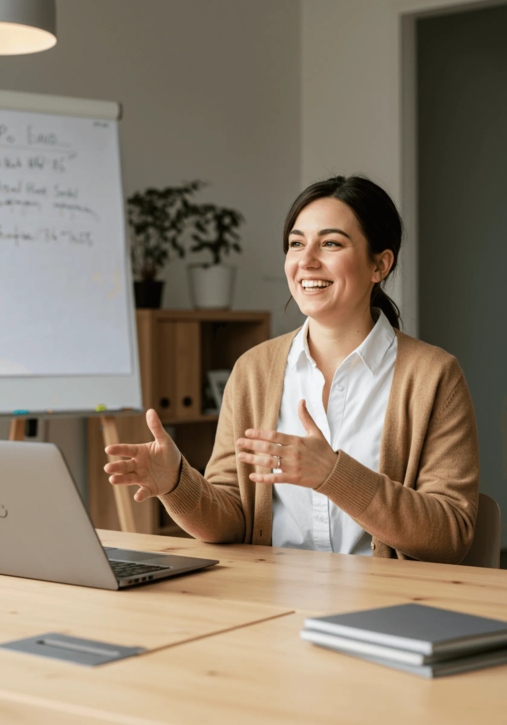 An advisor smiling and listening across a meeting table