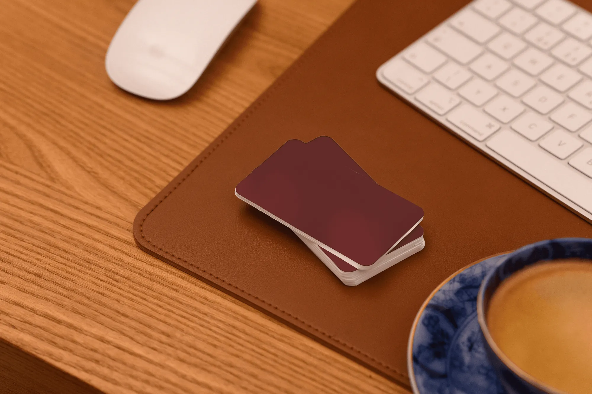 A stack of red cards on a leather desk pad