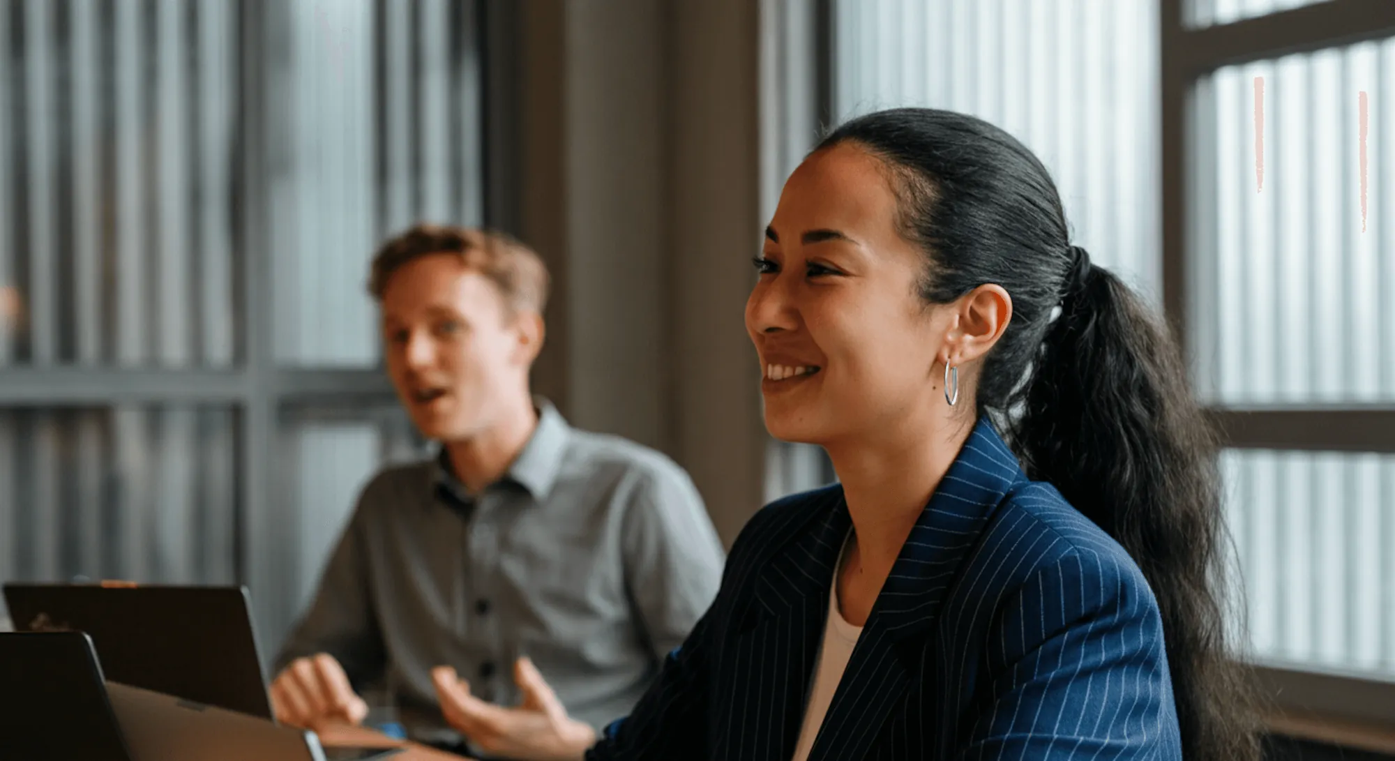 Two professionals discussing work in an office