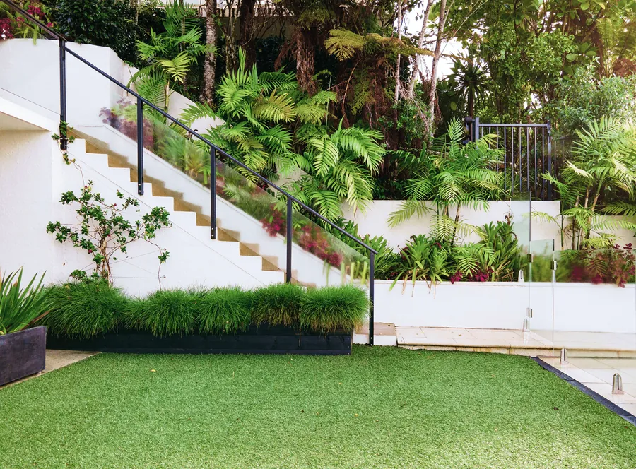A terraced garden with steps above a lawn