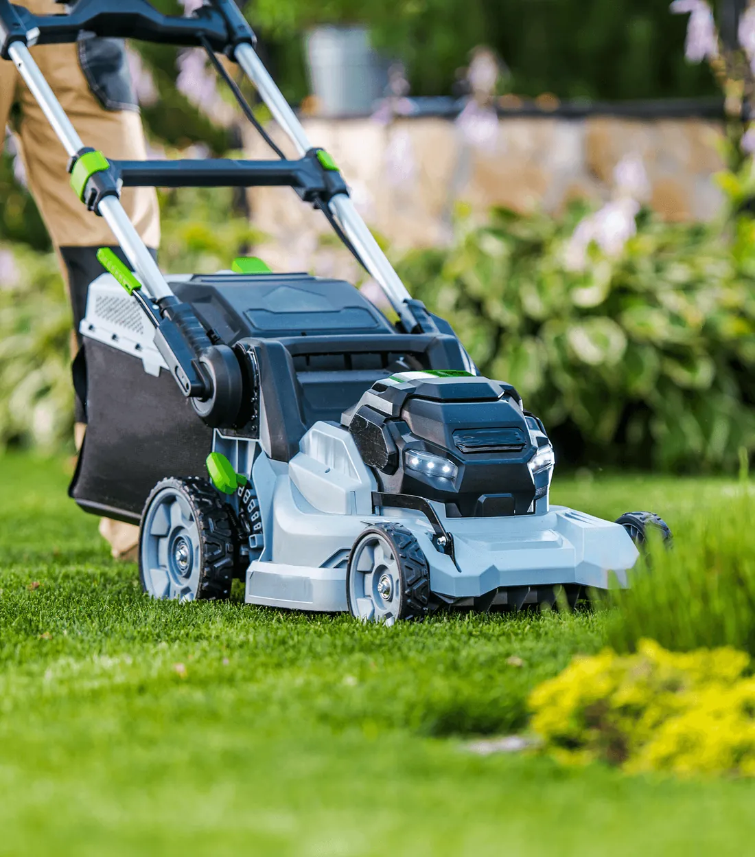 A cordless lawn mower on a freshly cut lawn