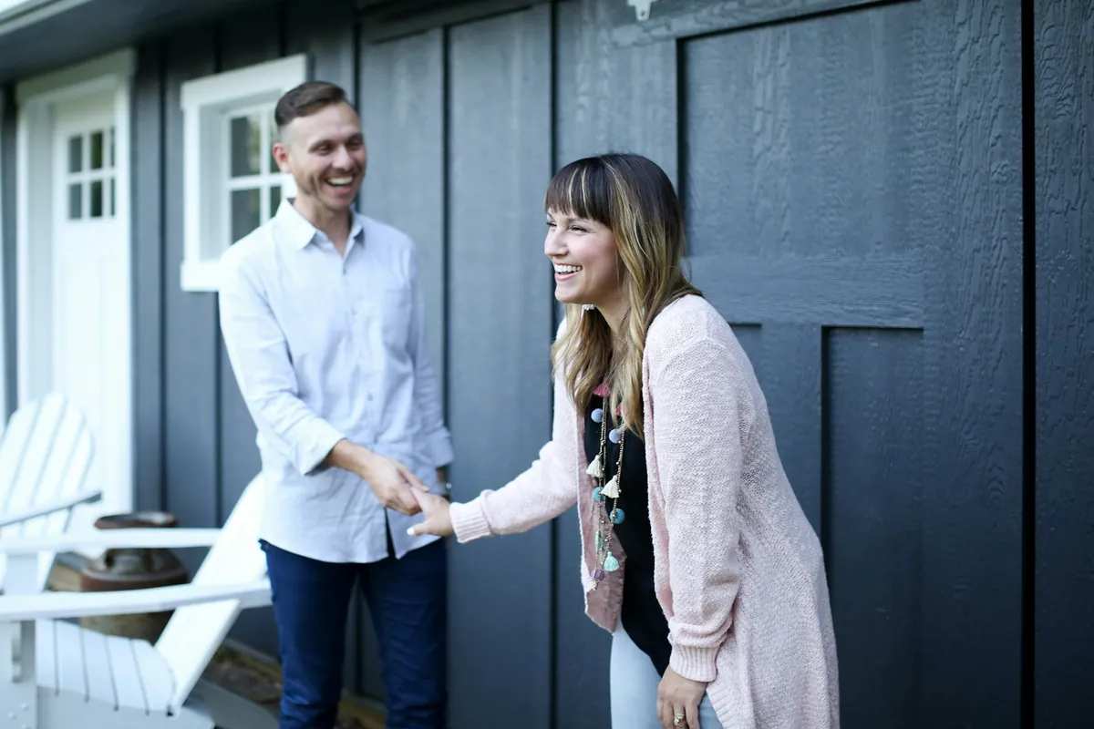 Homeowners greeting each other at their front door