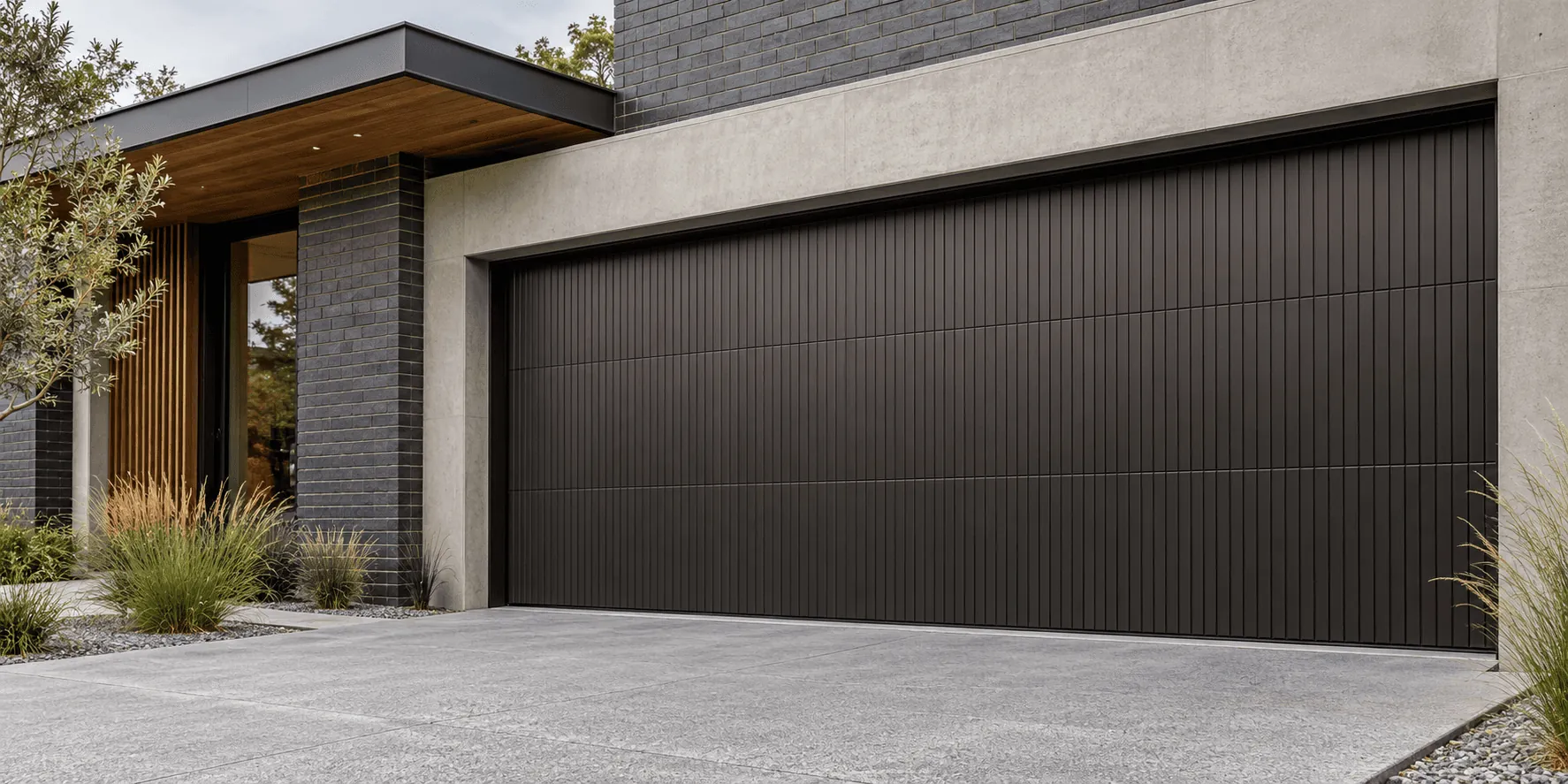 A dark vertical-ribbed steel garage door on a modern home