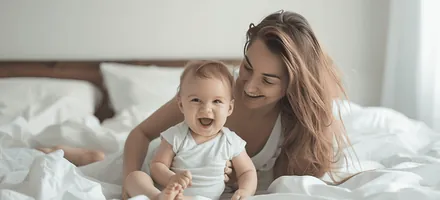 A mother with her baby in bed