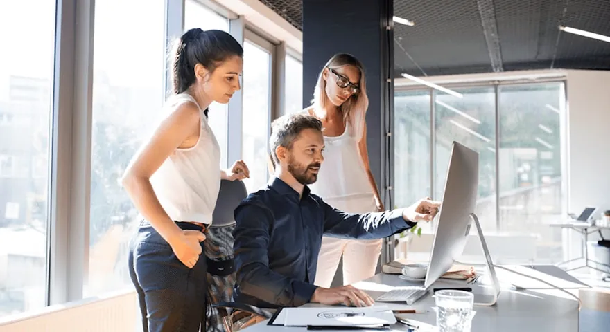 Colleagues working at a computer