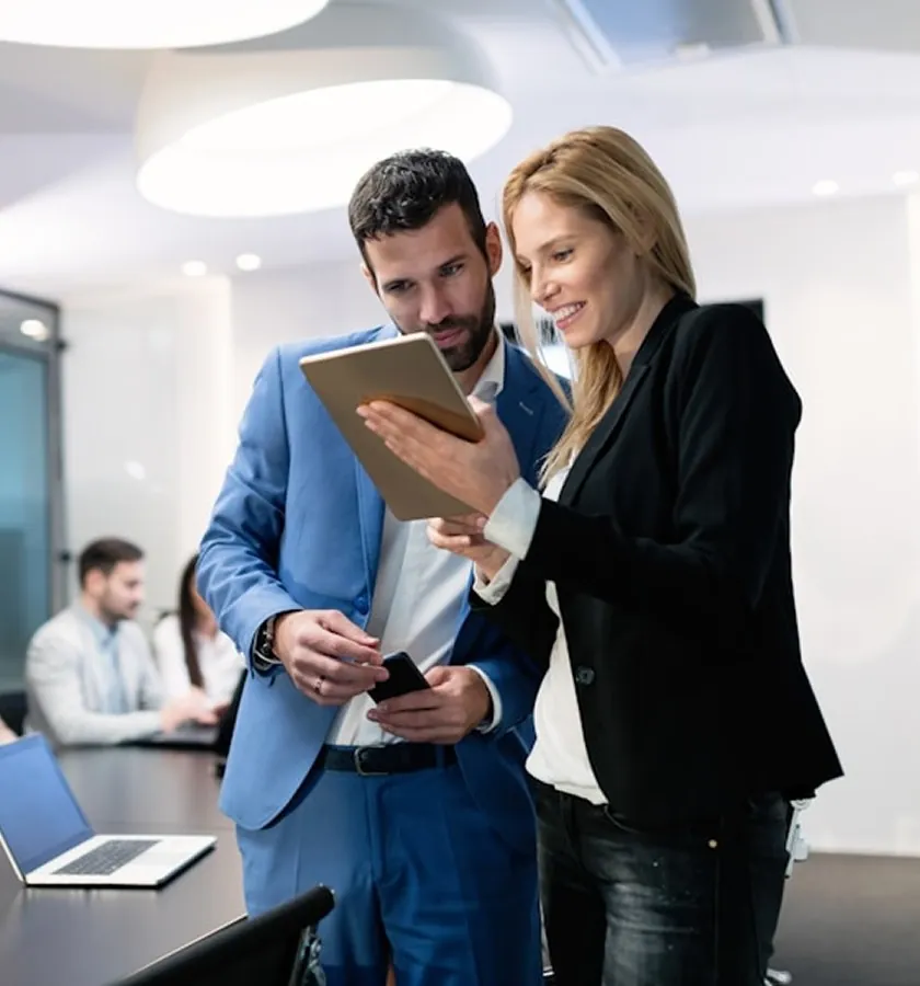 Two colleagues looking at a tablet