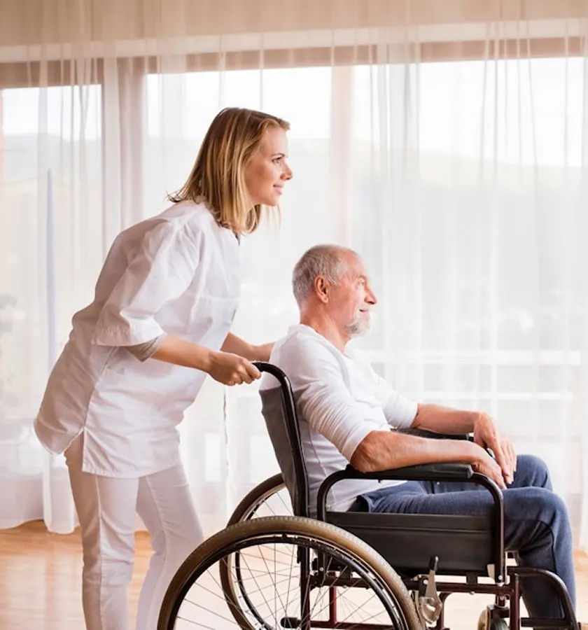 A nurse with an elderly man in a wheelchair