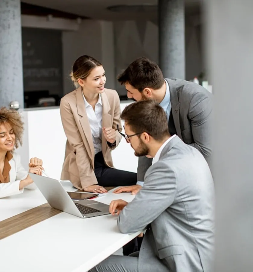 Colleagues around a laptop